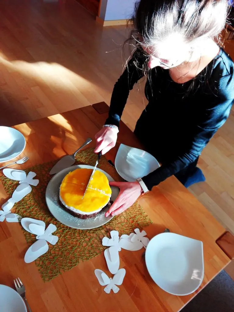 Kokos-Mango-Torte-vegan Kaja Neumann Ahafoods schneidet ihre Torte an